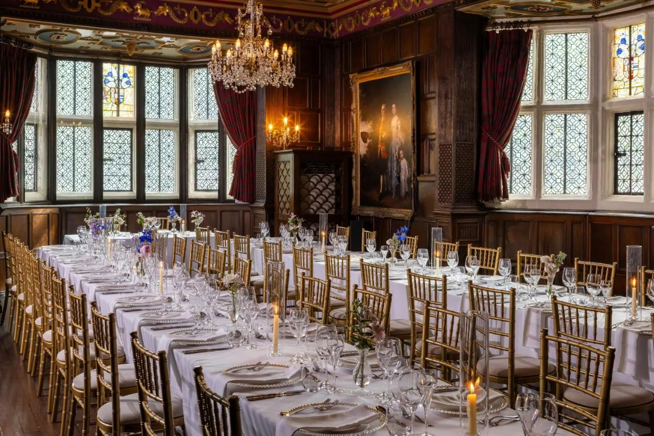 a room with long tables and chairs in a room with windows at New Hall Hotel & Spa, Birmingham in Birmingham